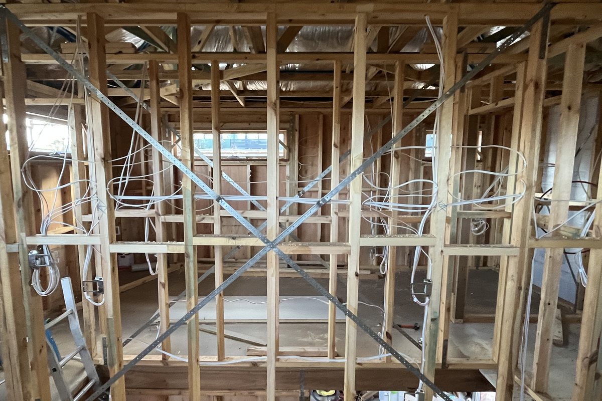 Timber wall frame of a house extension with electrical cables run and looped at each outlet and switch position, roughed in by SALTD Electrical