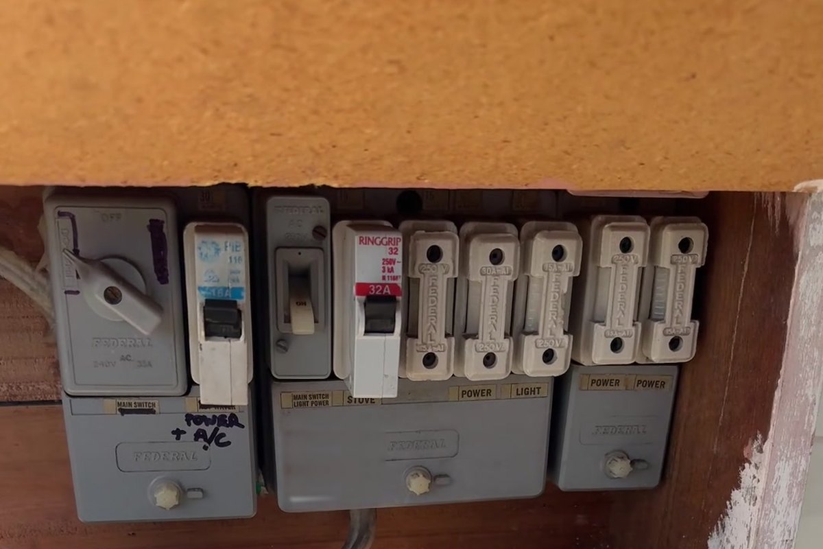 Old switchboard with ceramic rewireable fuses and no safety switches found during an electrical safety check by SALTD Electrical